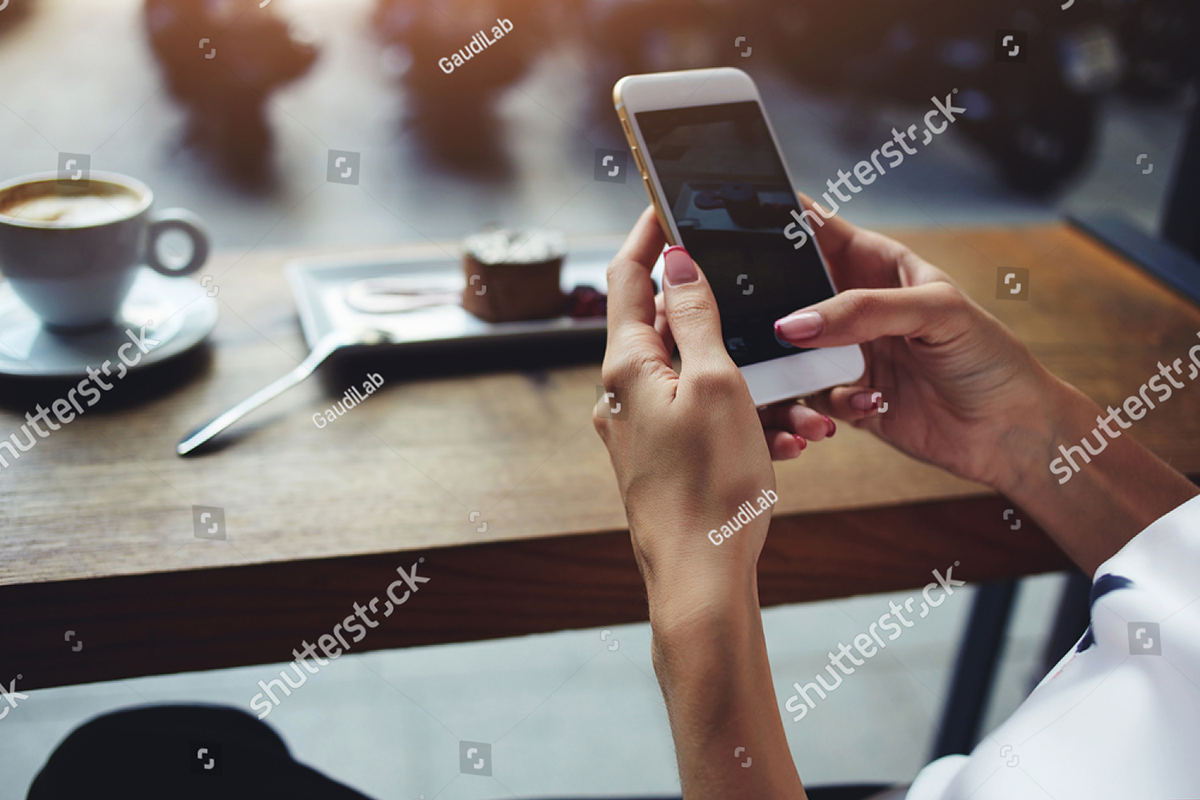 stock-photo-close-up-of-women-s-hands-holding-cell-telephone-with-blank-copy-space-scree-for-your-advertising-379989589