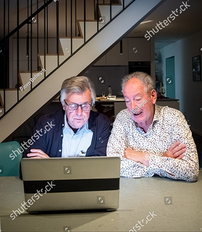 stock-photo-an-engaging-image-showcasing-two-senior-men-possibly-lifelong-friends-focused-on-a-laptop-screen-2404674147