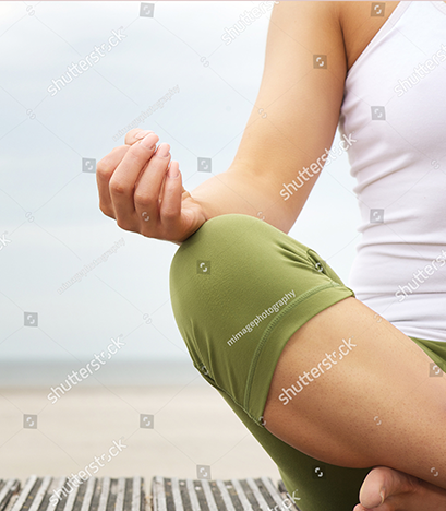 stock-photo-close-up-portrait-of-a-young-woman-in-lotus-position-with-yoga-hands-at-the-beach-143317846