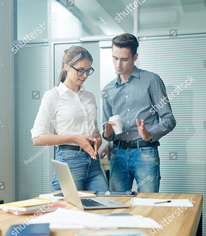 stock-photo-two-young-brokers-lookikng-through-online-data-and-discussing-it-708160624